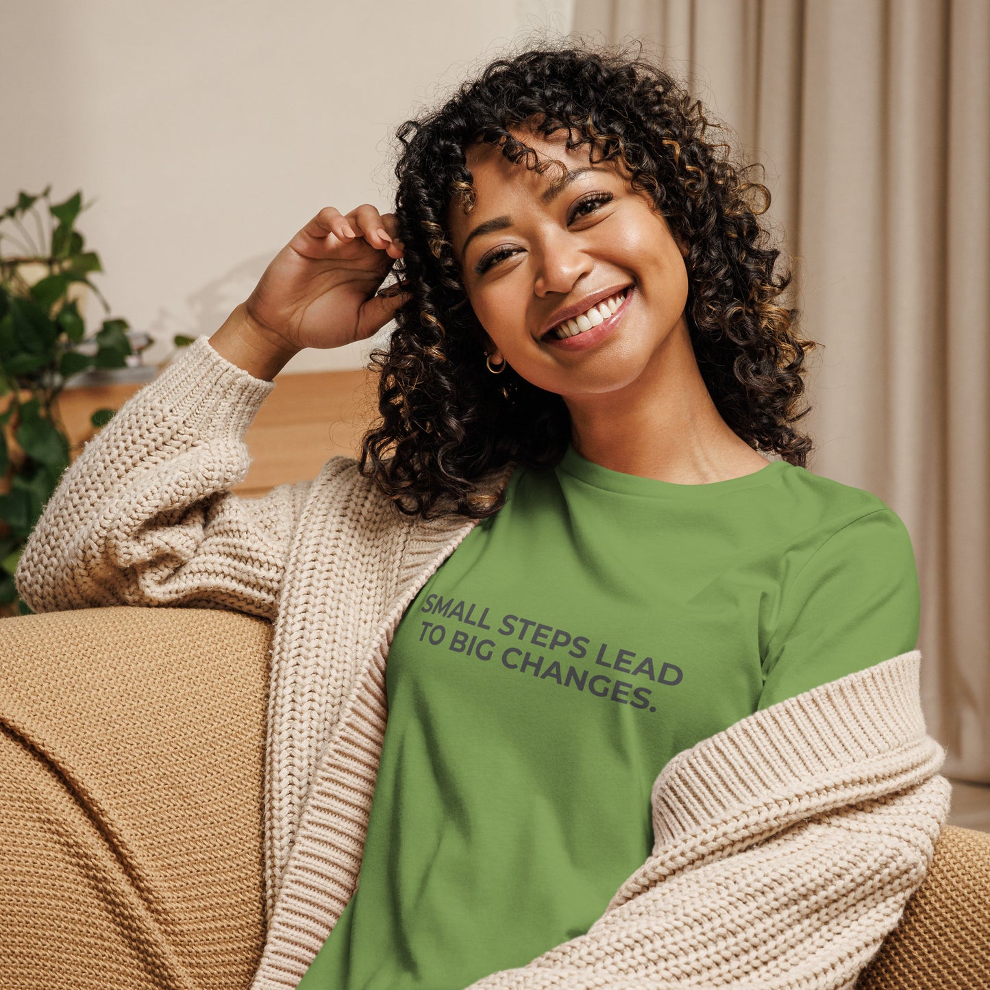 Woman wearing an leaf relaxed tee with "Small Steps Lead to Big Changes" printed.