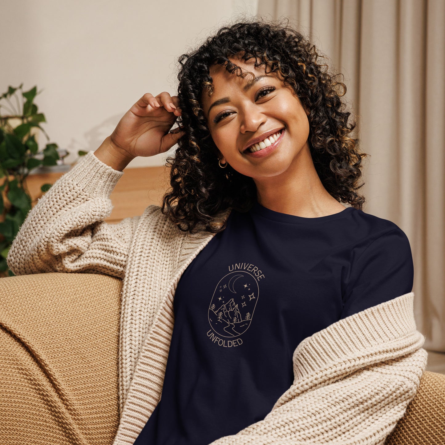 Woman smiling in a navy blue relaxed t-shirt with cosmic universe design