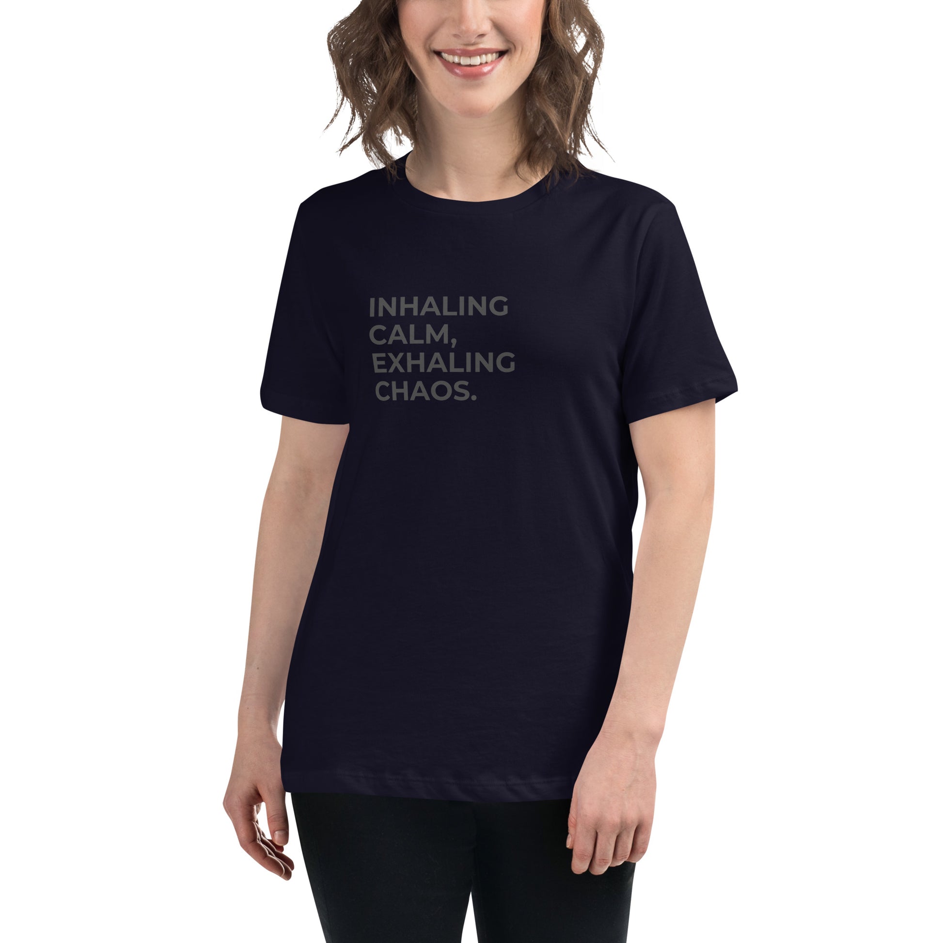 Woman wearing a navy relaxed tee with "Inhaling Calm, Exhaling Chaos" printed.