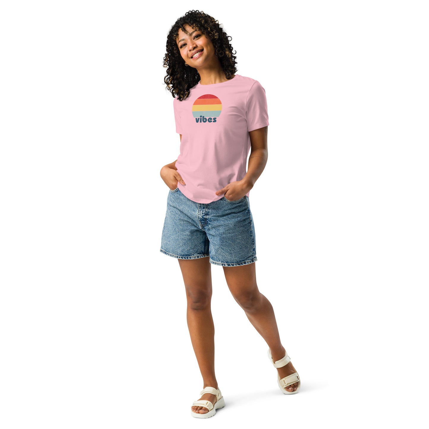 Woman wearing a pink relaxed t-shirt with retro 'good vibes' graphic