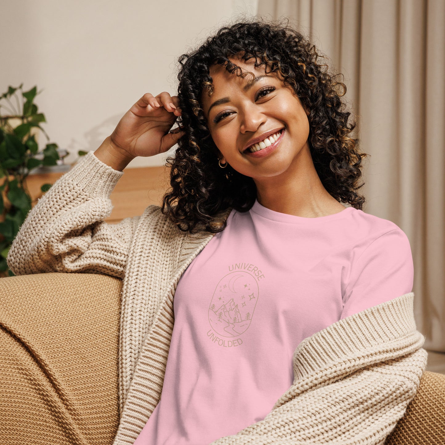 Woman smiling in a pink relaxed t-shirt with cosmic universe design