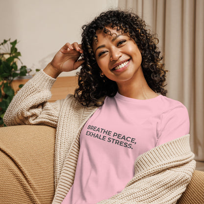 Woman wearing a pink relaxed tee with "Breathe Peace, Exhale Stress" printed.