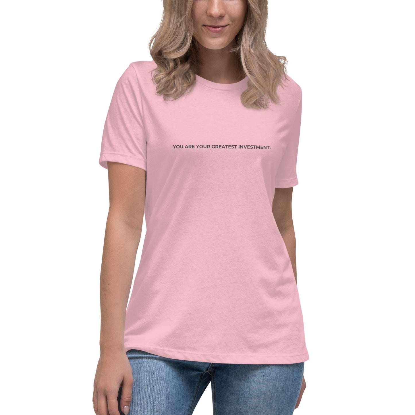 Woman wearing a pink relaxed tee with "You Are Your Greatest Investment" printed.