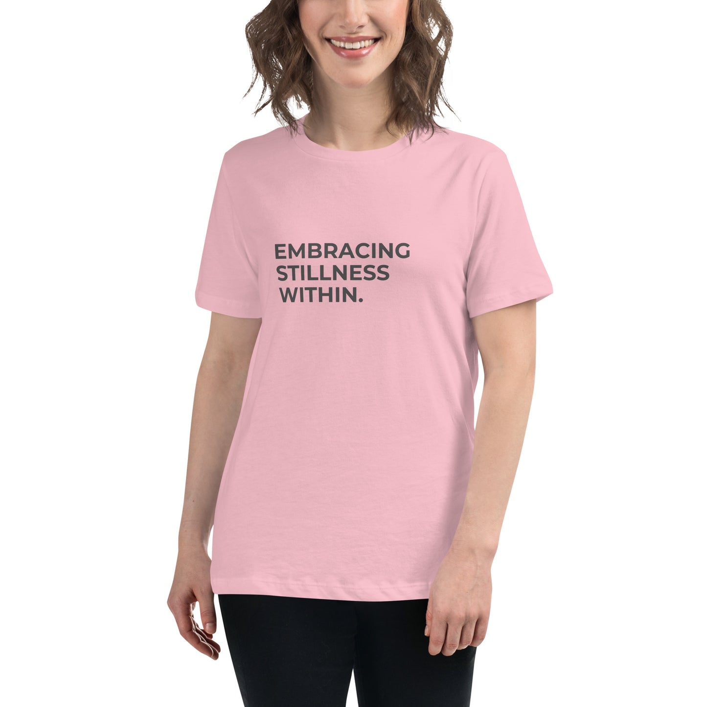 Woman wearing a pink relaxed tee with "Embracing Stillness Within" printed.