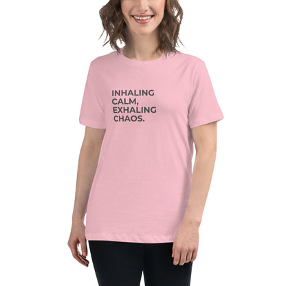 Woman wearing a pink relaxed tee with "Inhaling Calm, Exhaling Chaos" printed.