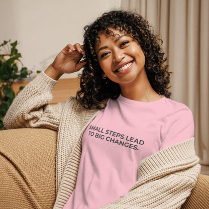 Woman wearing an pink relaxed tee with "Small Steps Lead to Big Changes" printed.