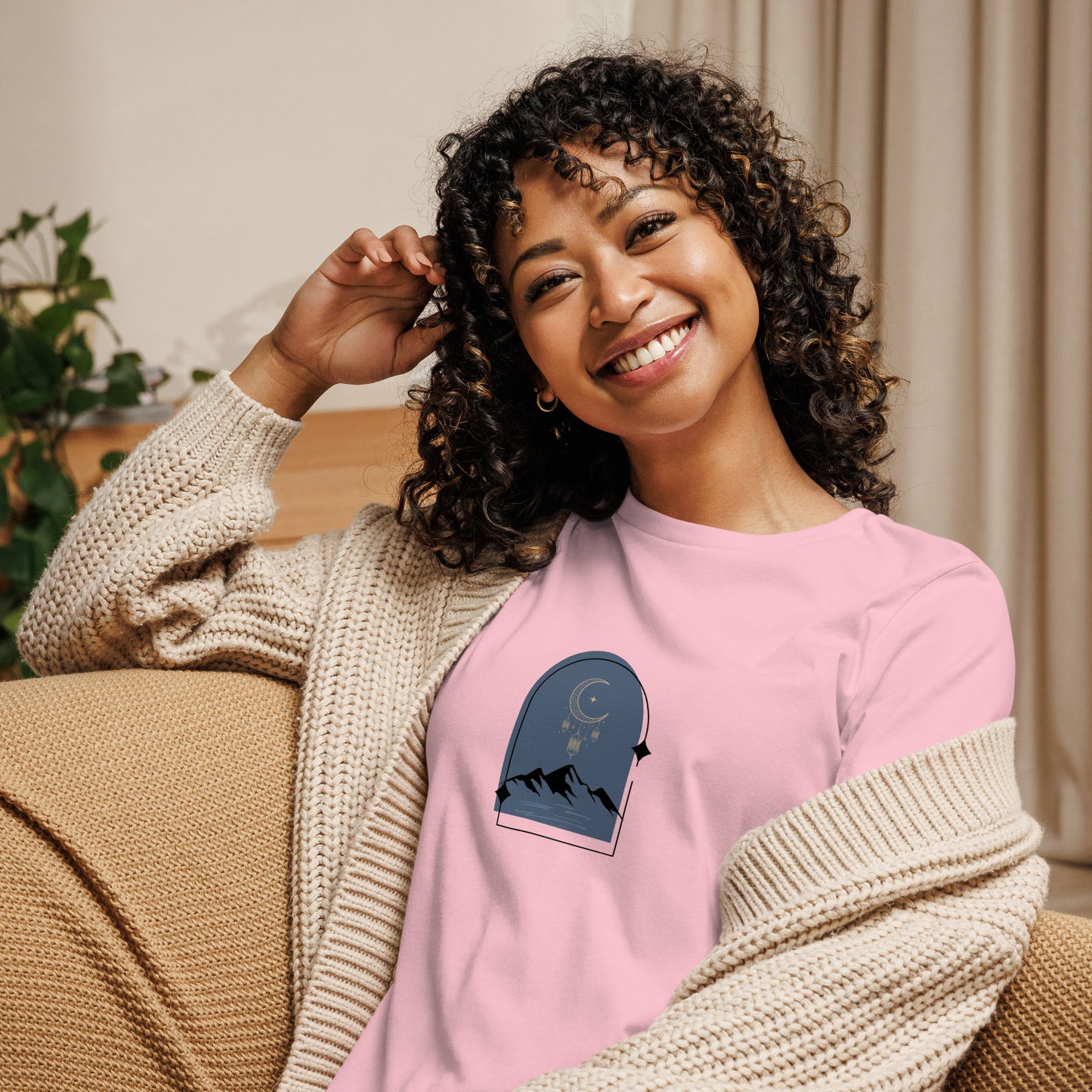 Woman wearing a pink relaxed tee with a tranquil night sky graphic design, representing comfortable and authentic fashion by BYOL.