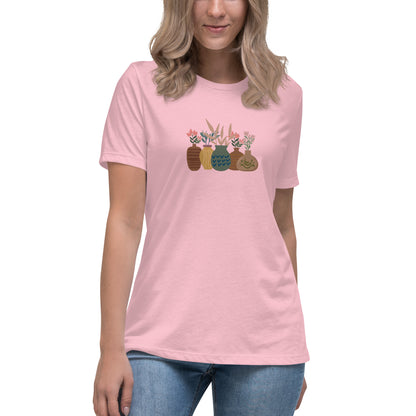 Woman wearing a pink relaxed tee with a charming vase floral graphic design, embodying comfortable and authentic fashion by BYOL.