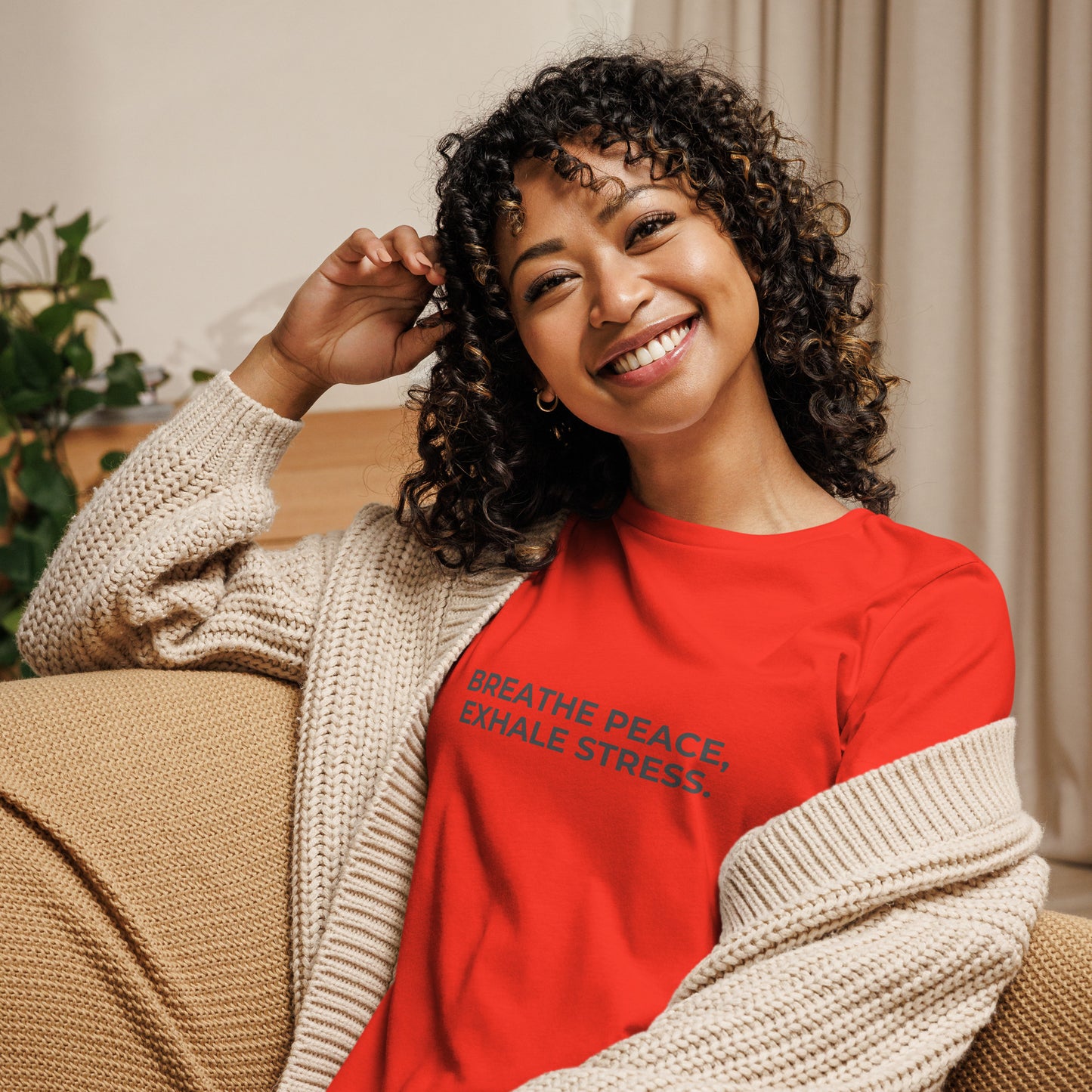 Woman wearing a berry relaxed tee with "Breathe Peace, Exhale Stress" printed.