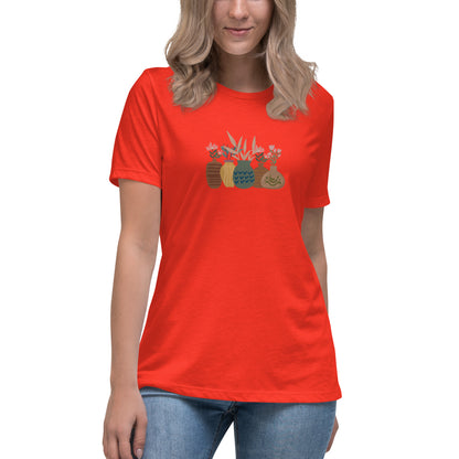 Woman wearing a poppy relaxed tee with a charming vase floral graphic design, embodying comfortable and authentic fashion by BYOL.