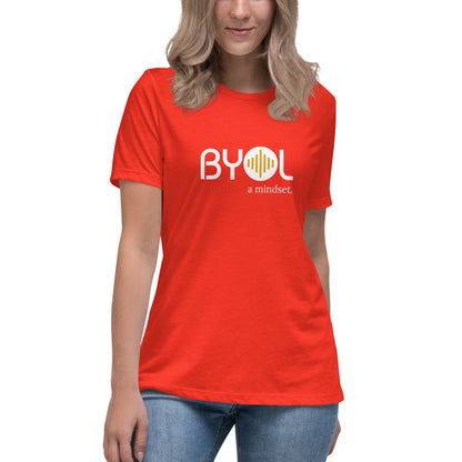 Woman wearing a poppy relaxed fit BYOL mindset t-shirt  with color options in black, pink, blue, and gray, available in sizes S to 3XL.