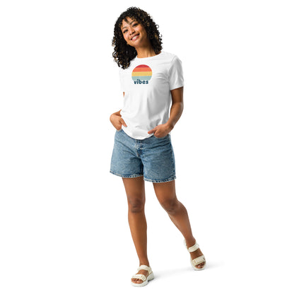 Woman wearing a white relaxed t-shirt with retro 'good vibes' graphic