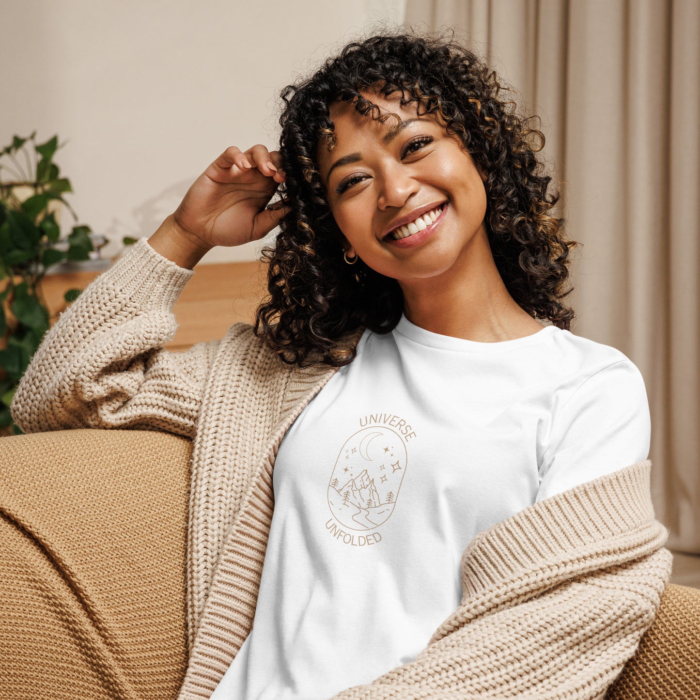 Woman smiling in a white relaxed t-shirt with cosmic universe design