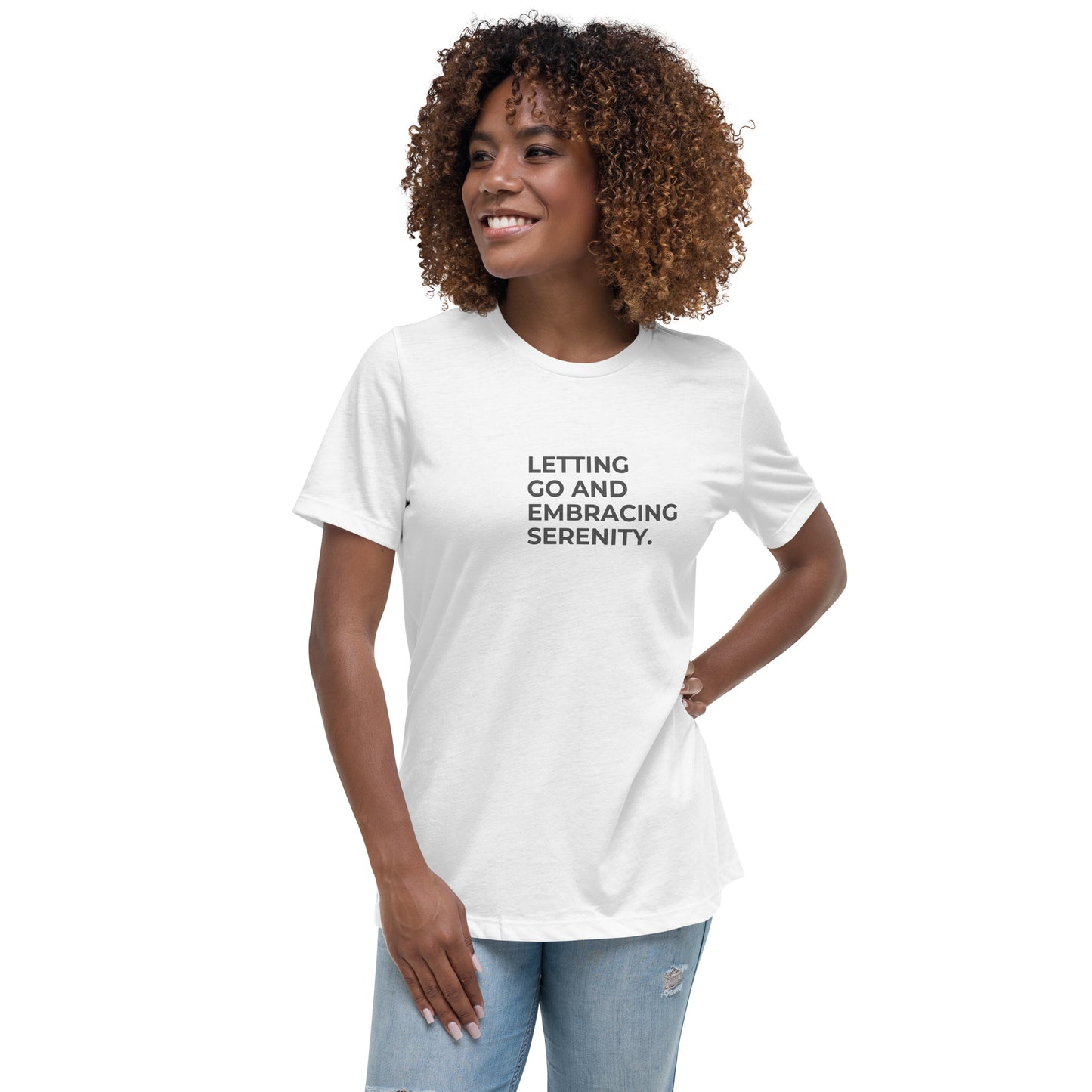 Woman wearing a white relaxed tee with "Letting Go and Embracing Serenity" printed, available in various colors and sizes from S-3XL.