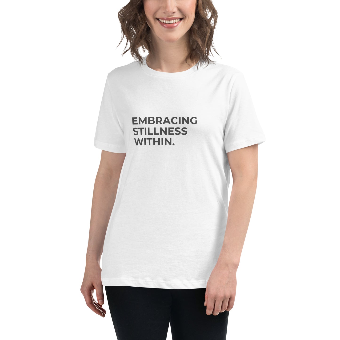 Woman wearing a white relaxed tee with "Embracing Stillness Within" printed.