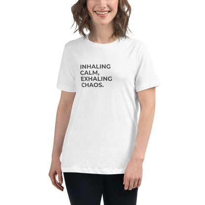 Woman wearing a white relaxed tee with "Inhaling Calm, Exhaling Chaos" printed.