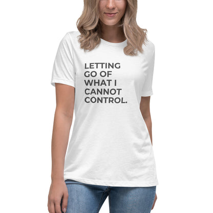 Woman wearing a white relaxed tee with "Letting Go of What I Cannot Control" printed.