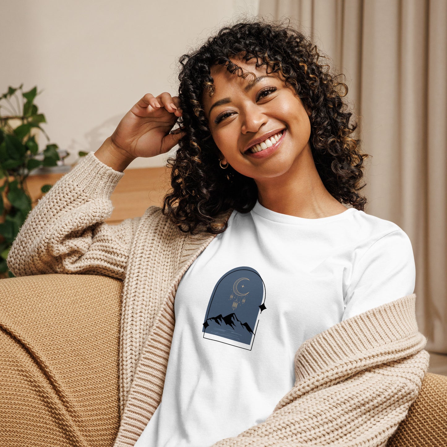 Woman wearing a white relaxed tee with a tranquil night sky graphic design, representing comfortable and authentic fashion by BYOL.