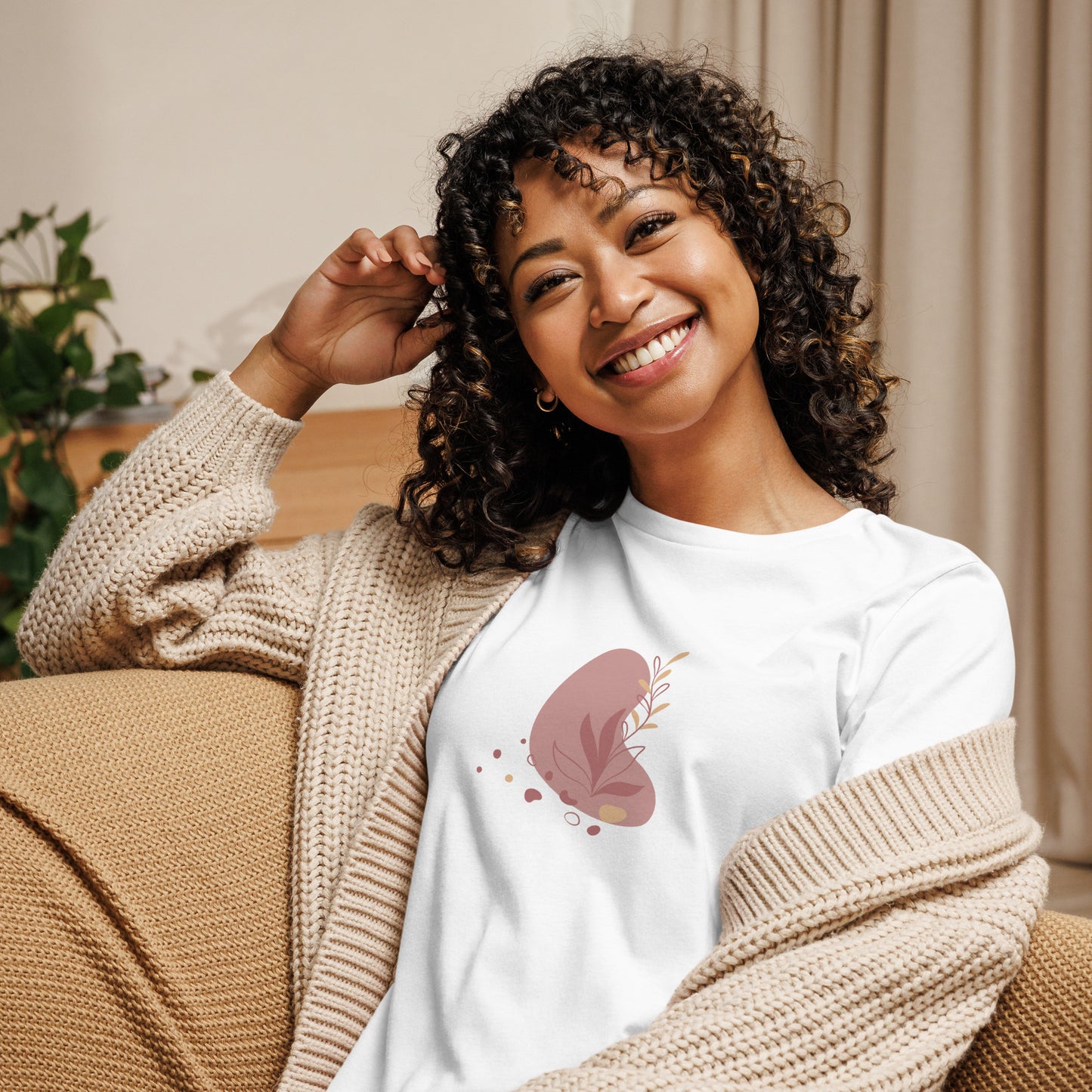 Woman wearing a white relaxed tee with a subtle abstract floral graphic design, embodying comfortable and authentic fashion by BYOL.