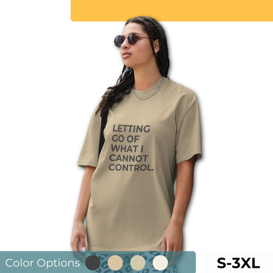 Woman wearing a faded oversized tee in various colors and sizes S-3XL, featuring the phrase "Letting Go of What I Cannot Control."